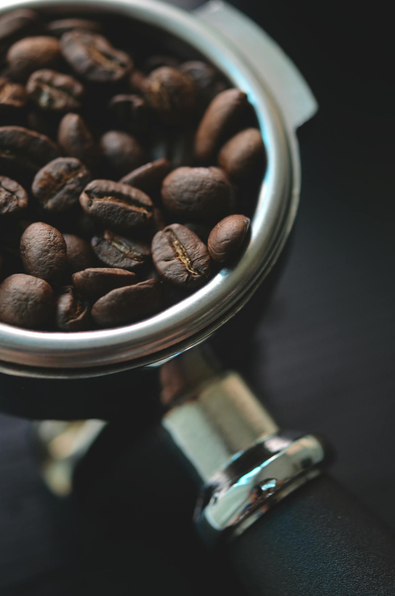 A coffee beans in a brewing cup Photo by Photo by Chevanon Photography: https://www.pexels.com/photo/close-up-of-coffee-beans-in-bowl-333523/