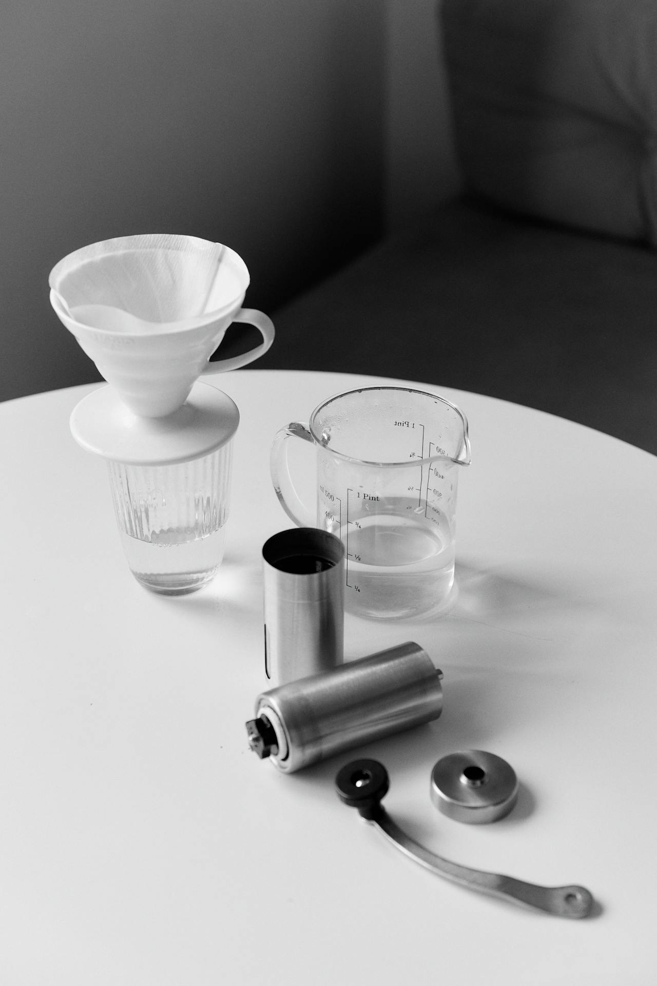 A coffee grinder and scale and gear. Photo by Darina Belonogova: https://www.pexels.com/photo/coffee-grinder-and-scale-gear-8004606/